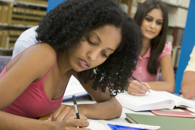 female student writing an essay